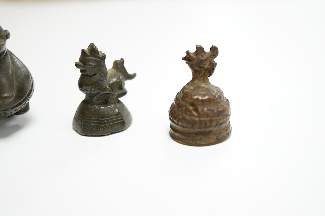 Two 19th century Burmese bronze weights, and a similar figure of a mythical beast, largest 4cm high
